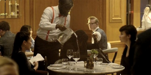 Oli Farmoudun in character as a waiter at Gillray's steakhouse in London, before surprising his fiance Yemisi with a marriage proposal after a flash mob has erupted in song.