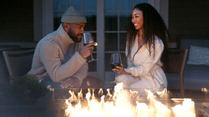 couple drinking wine fireside.