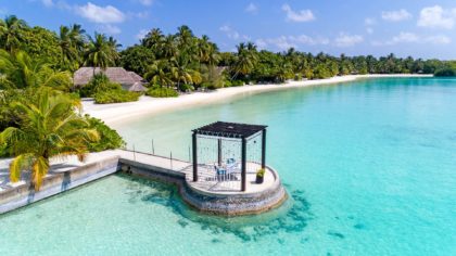 A dining pavilion for two over the water at the Sheraton Maldives Full Moon Resort and Spa.