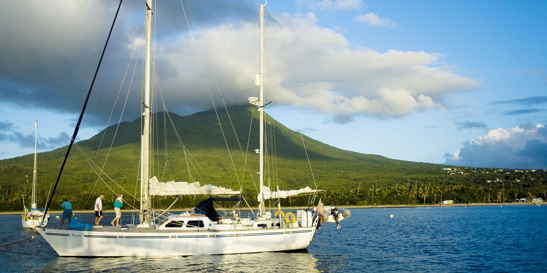nevis peak in the distance behind sailboat