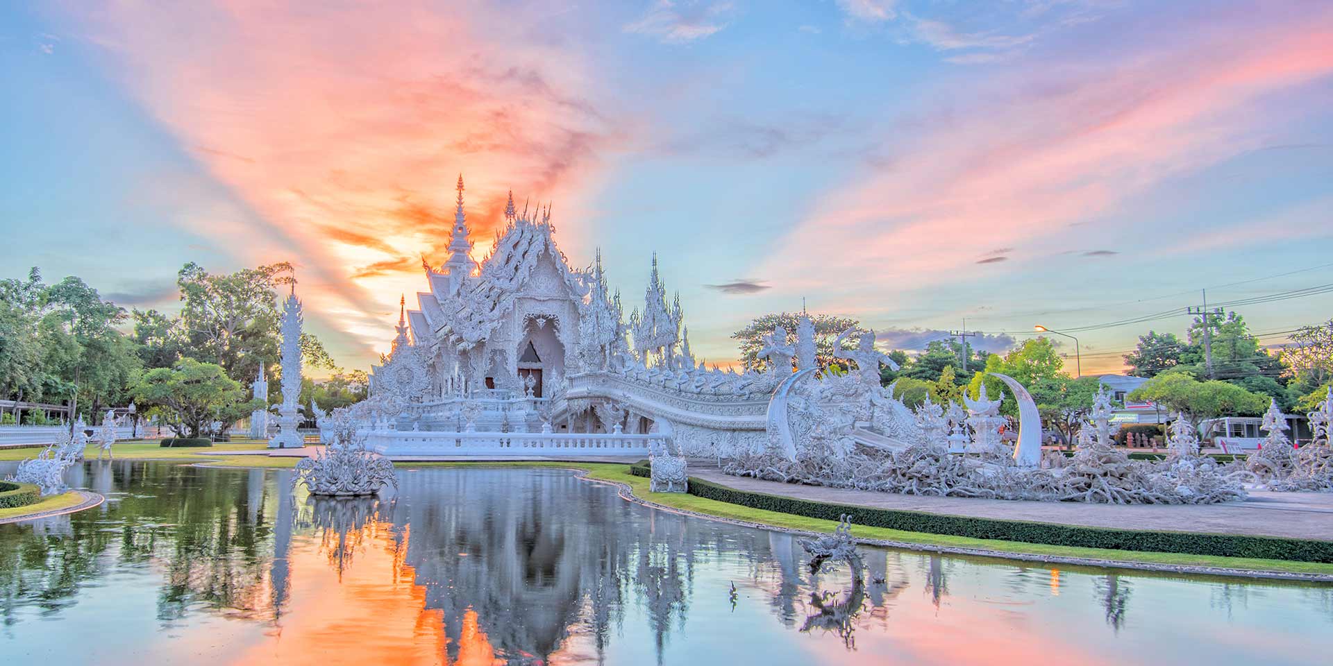 wat rong khun temple in thailand at sunset