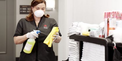 hotel associate spraying cleaning cloths