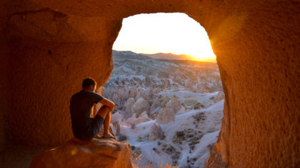 man sitting in cave in cappodoccia