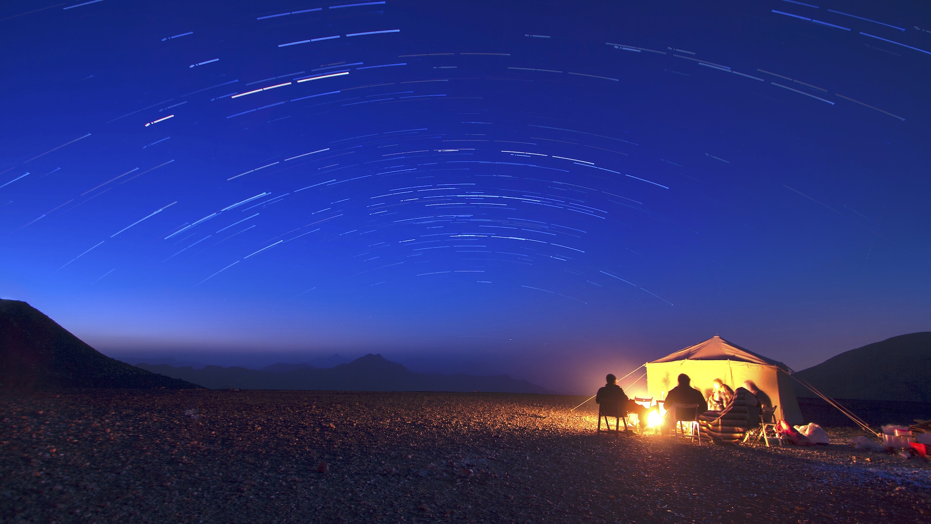 campers in desert in middle east under stars