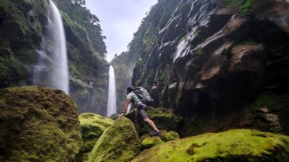 man hiking at waterfall in costa rica