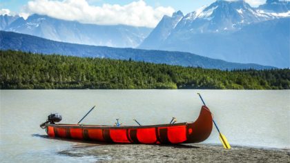 canoe with mountains in alaska