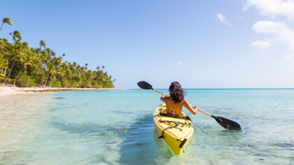 Woman Kayaking in Fiji on a sunny day.