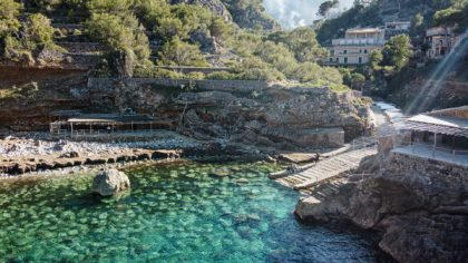 stairs leading to rocky beach and water in mallorca