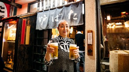 woman in japan holding two pints of beer