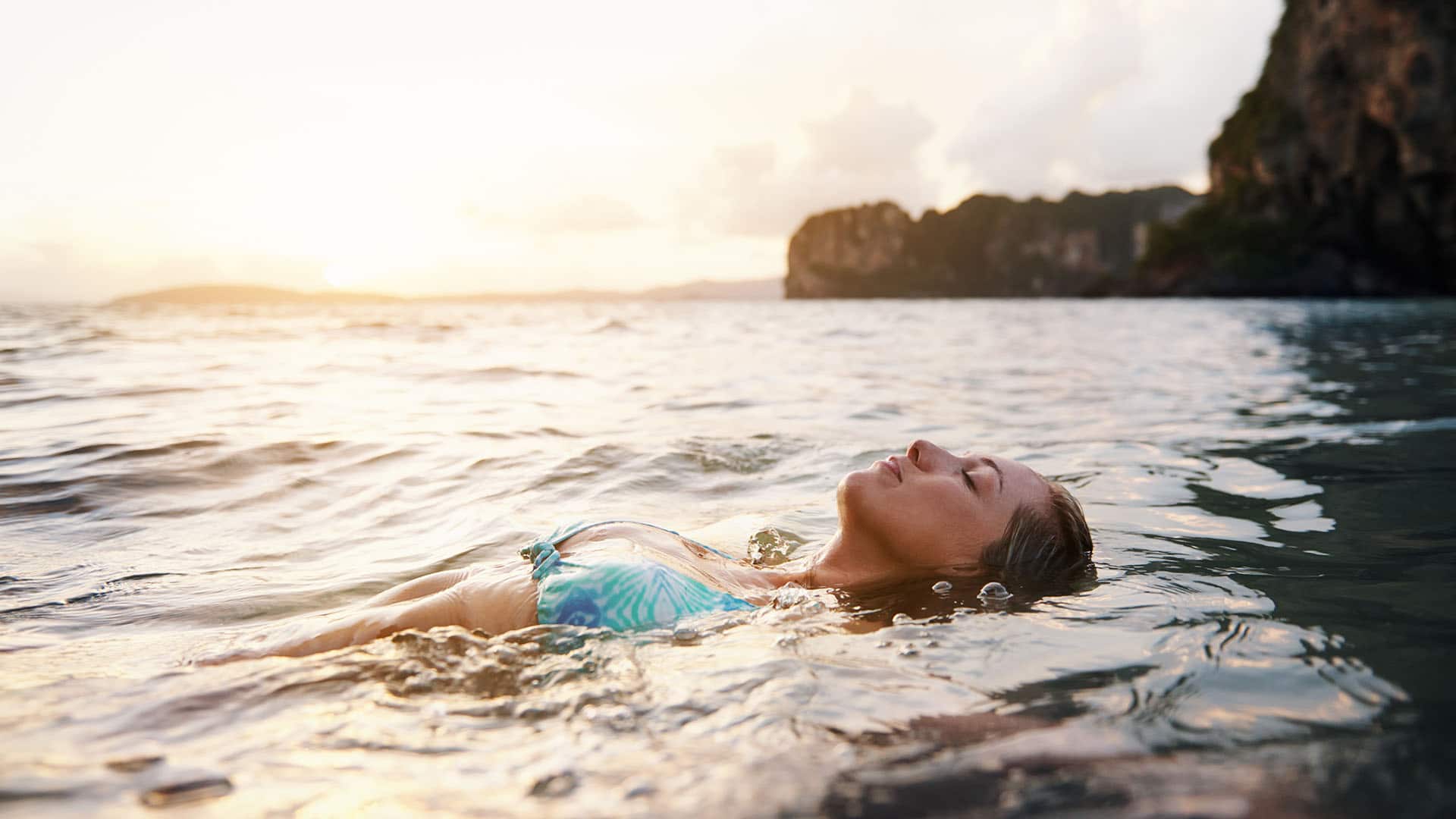 woman swimming with eyes closed