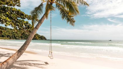 Swing attached to palm tree overlooking the beach in Phu Quoc, Vietnam