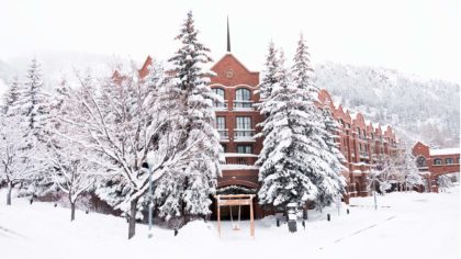 The St. Regis Aspen Resort in the middle of winter covered in white snow.