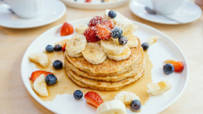 Banana and berry pancakes with syrup