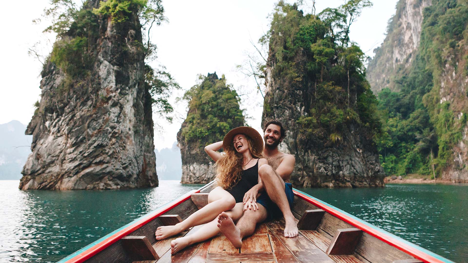 Couple in boat smiling in Thailand