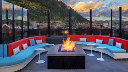 Fire pit and fun lounge with mountains in the background at the W Asper
