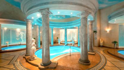 Pools surrounded by roman columns and statues at the spa at Le Royal Méridien Beach Resort & Spa