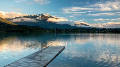 Dock over lake with mountains in the background in Whistler.