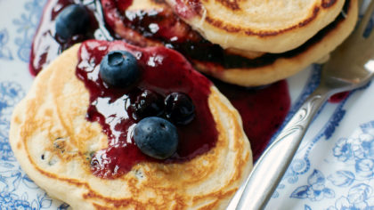 Pancakes covered in blueberry jam