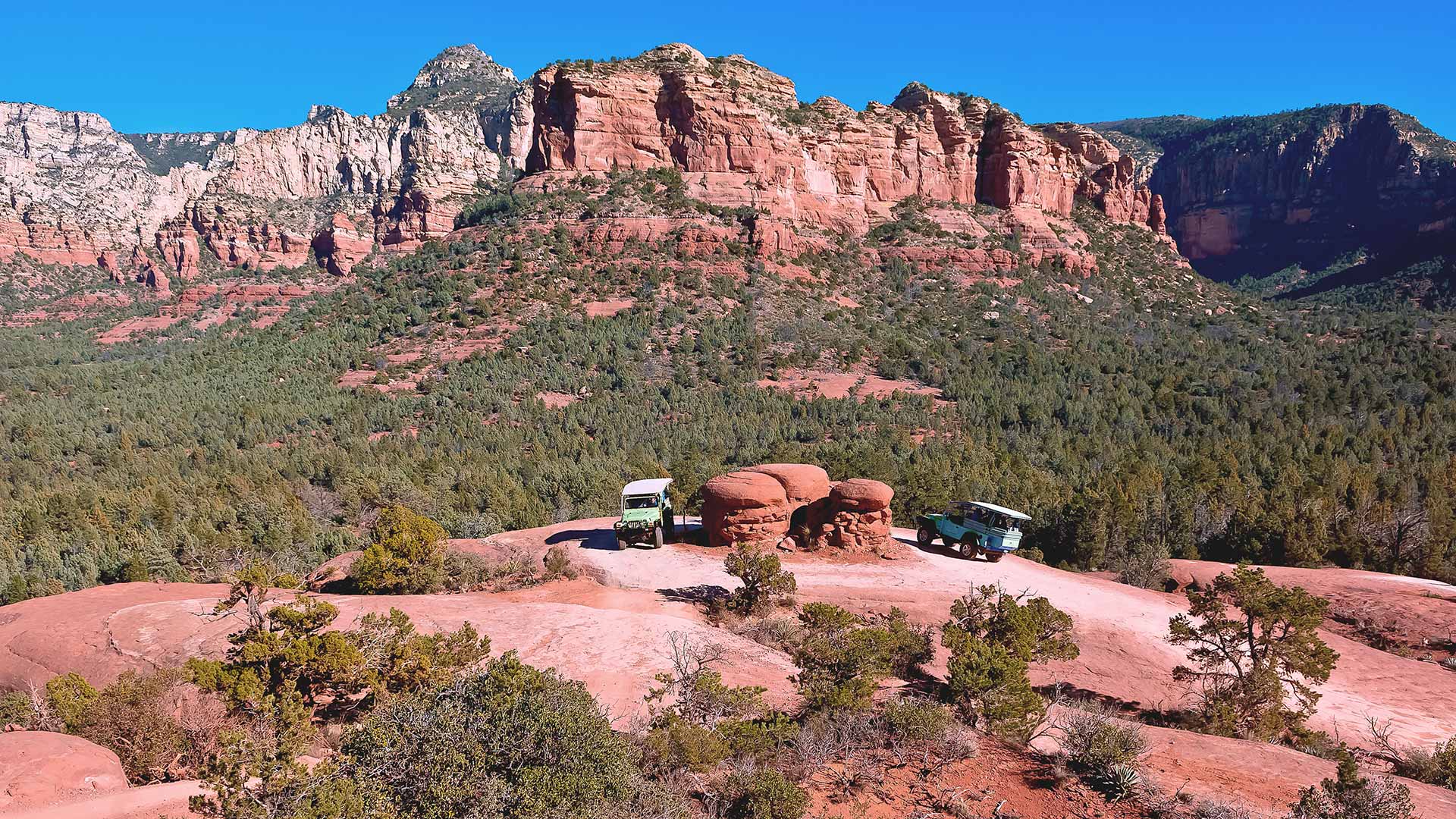 Chicken point in Sedona with two parked Jeeps