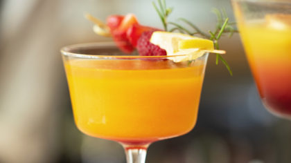 Orange cocktail with fruit and rosemary