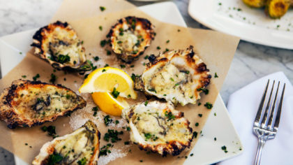 Oysters Rockefeller with lemon and a fork