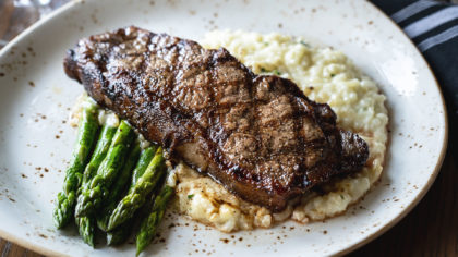 Plate with risotto steak and asparagus