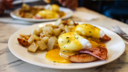 Eggs Benedict with ham and breakfast potatoes