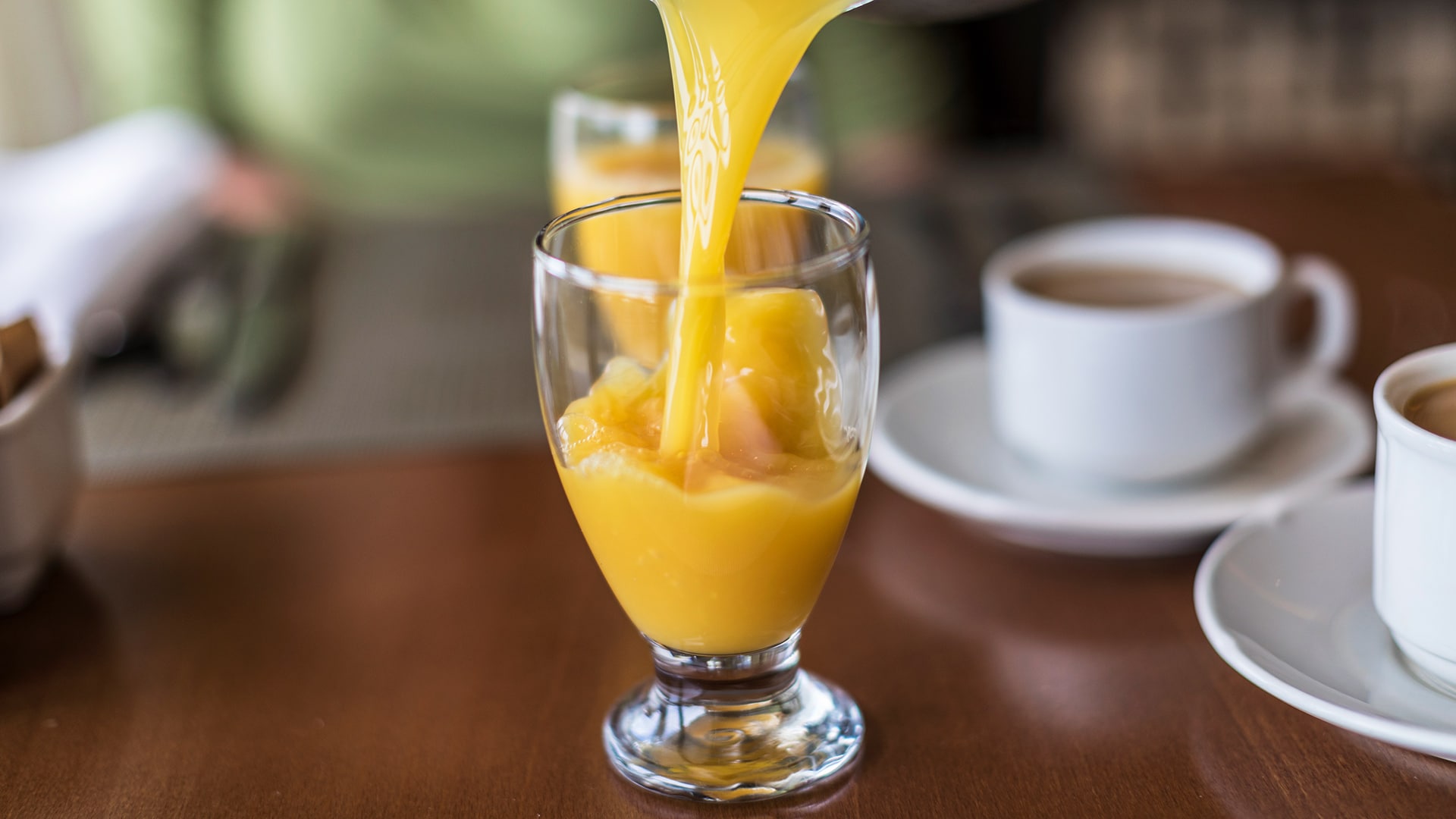 Orange juice being poured in a glass