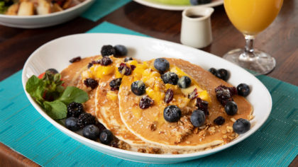 Pancakes with blueberries and orange juice