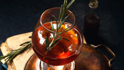 Bourbon cocktail with rosemary sprig garnish