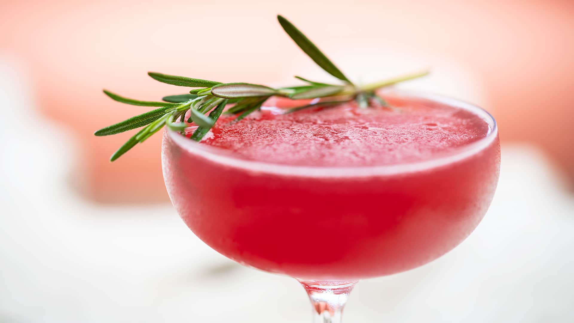 Red frozen cocktail with rosemary spring
