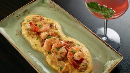 Shrimp and grits with a cocktail