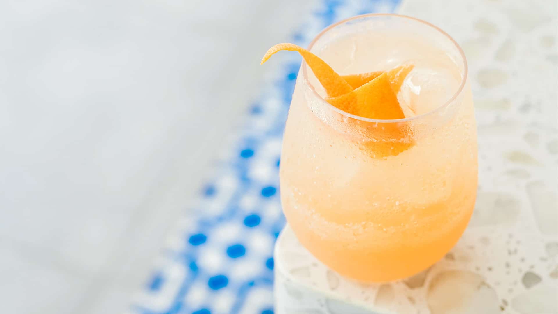 Orange cocktail in glass with garnish