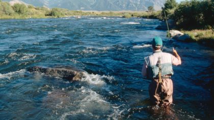 Person fly fishing in river in Bozeman
