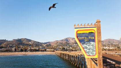 Sign for Ventura Pier with mountains in background
