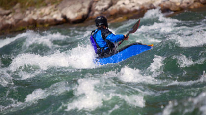 Kayaker going through rapids
