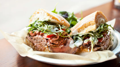 Roast beef sandwich with greens and tomatoes