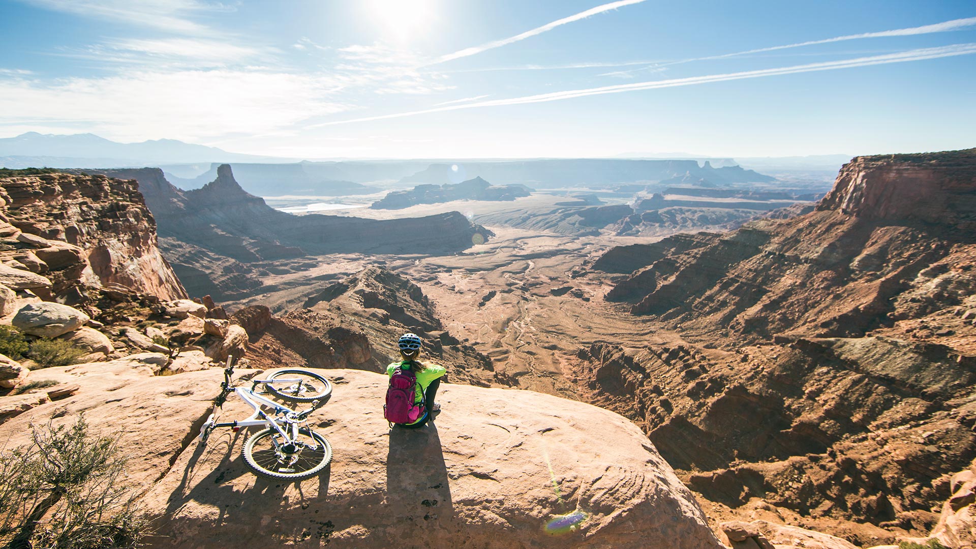 Mountain biker sitting on cliff in Moab
