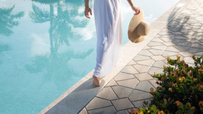 Woman walking by a pool