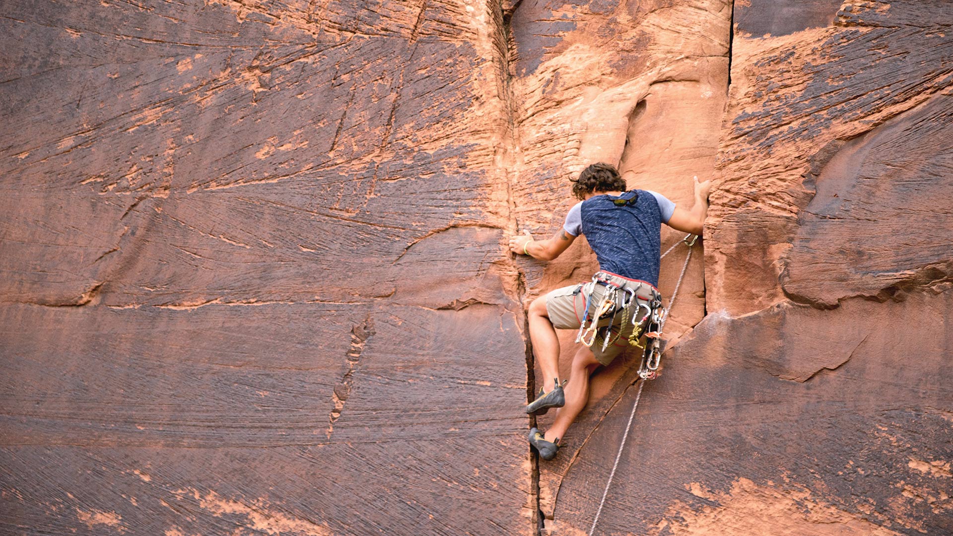 Rock climber scaling wall