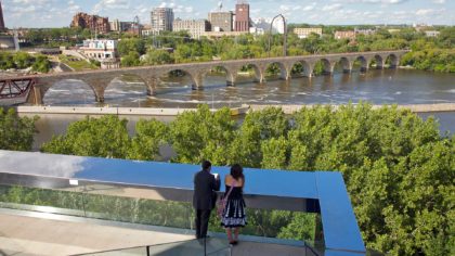 Couple looking at view of the Stone Arch Bridge from the Guthrie Theater