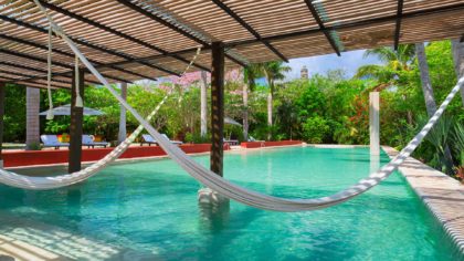 hacienda san jose pool with hammocks