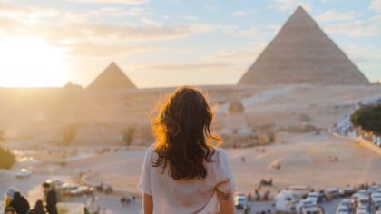 woman looking at pyramids in cairo