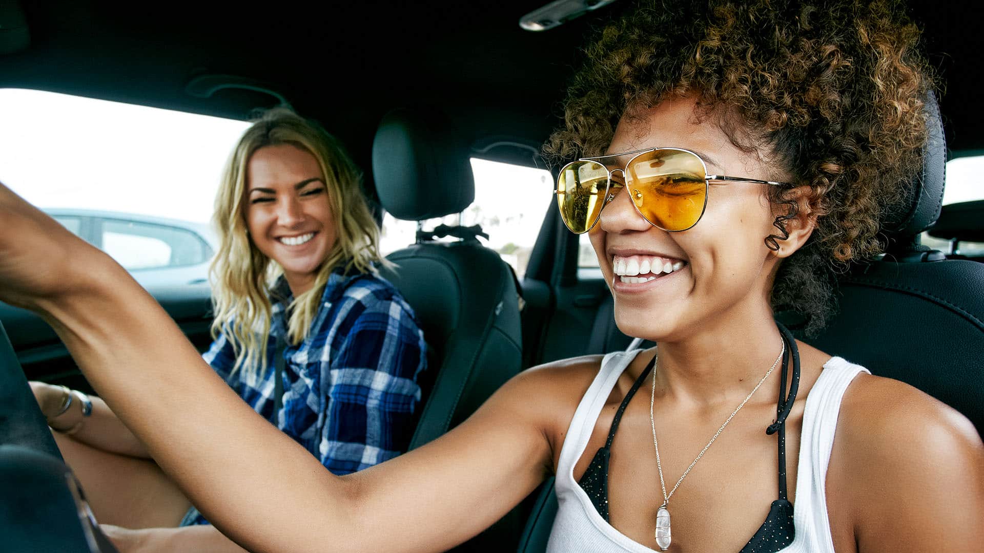 two women laughing in car