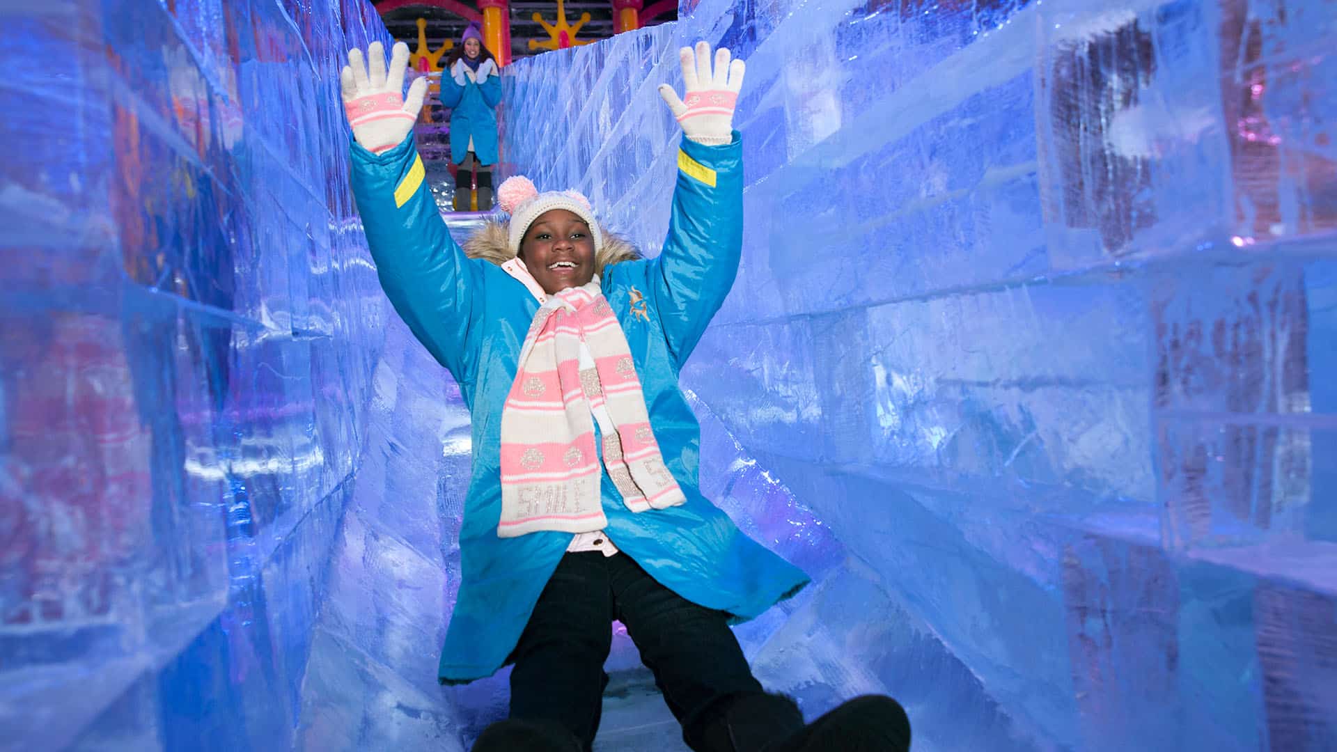 a girl going down the ice slide