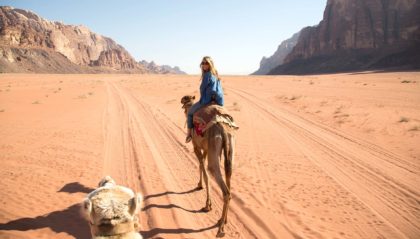 A girl riding a camel in Jordan