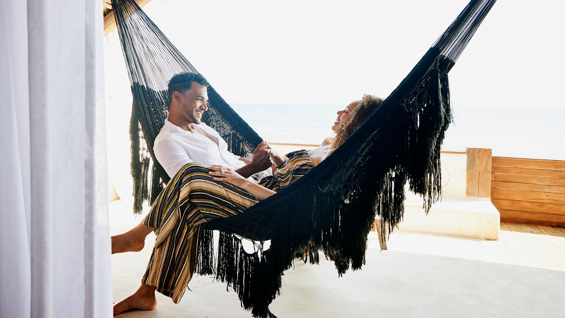 a couple in hammocks