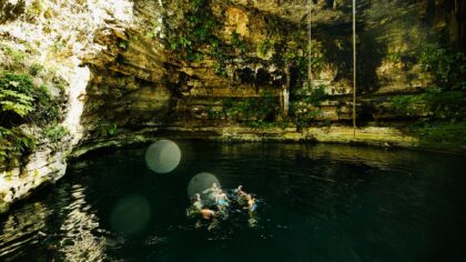 friends swimming in a cenote in the yucatan