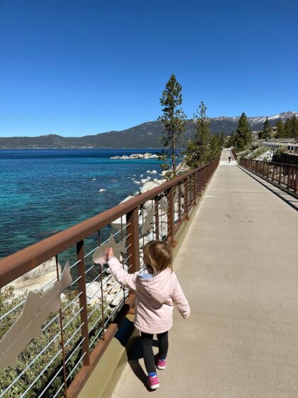 Child walking along East Shore Trail in Lake Tahoe, Nevada.