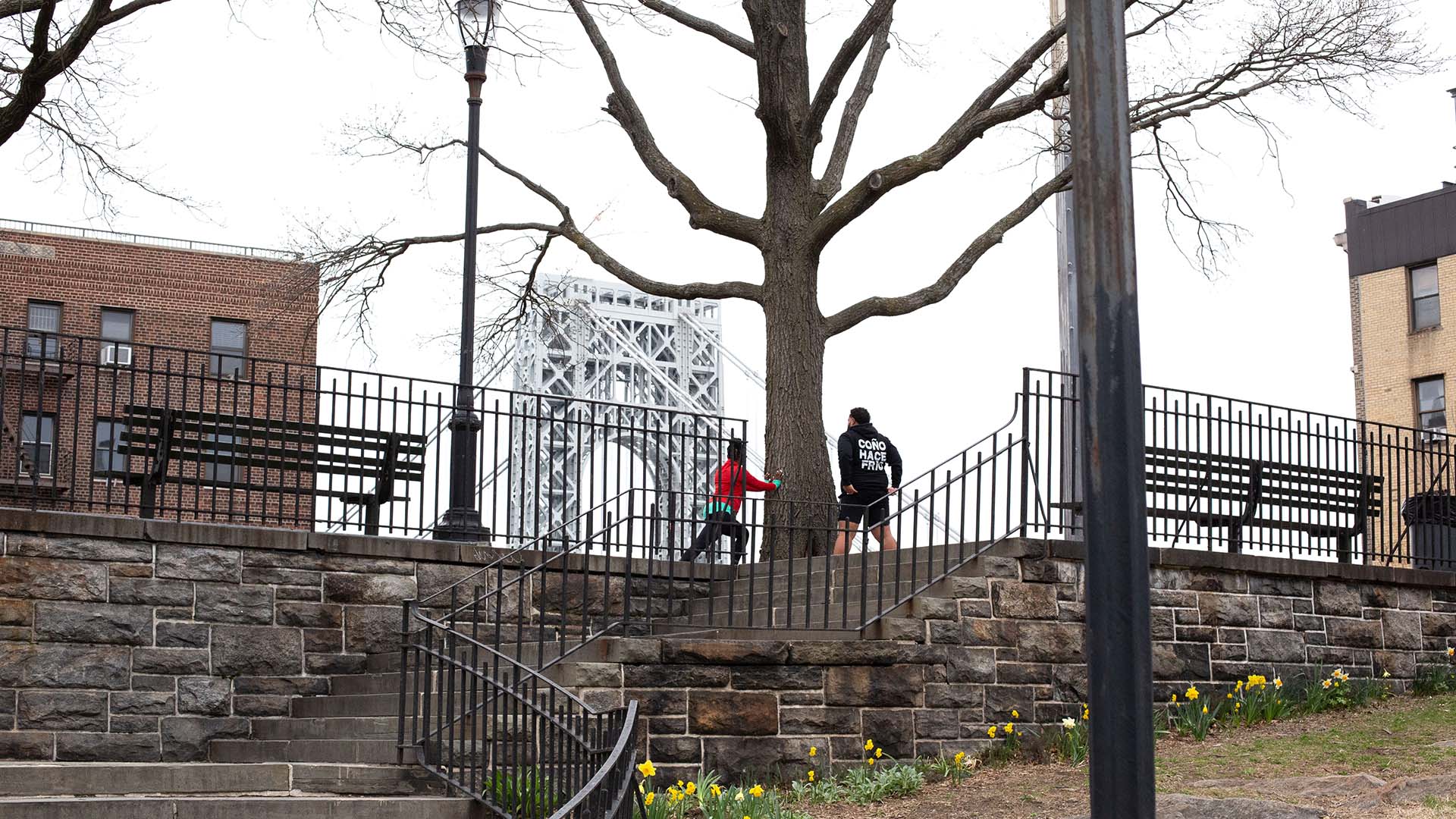 About the Journey podcast host Oneika Raymond and We Run Uptown founder Hector Espinal running by the George Washington Bridge in Washington Heights, New York City